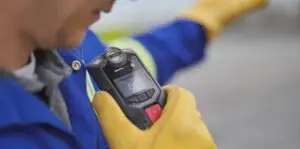 A mans hand holding blackline safety device